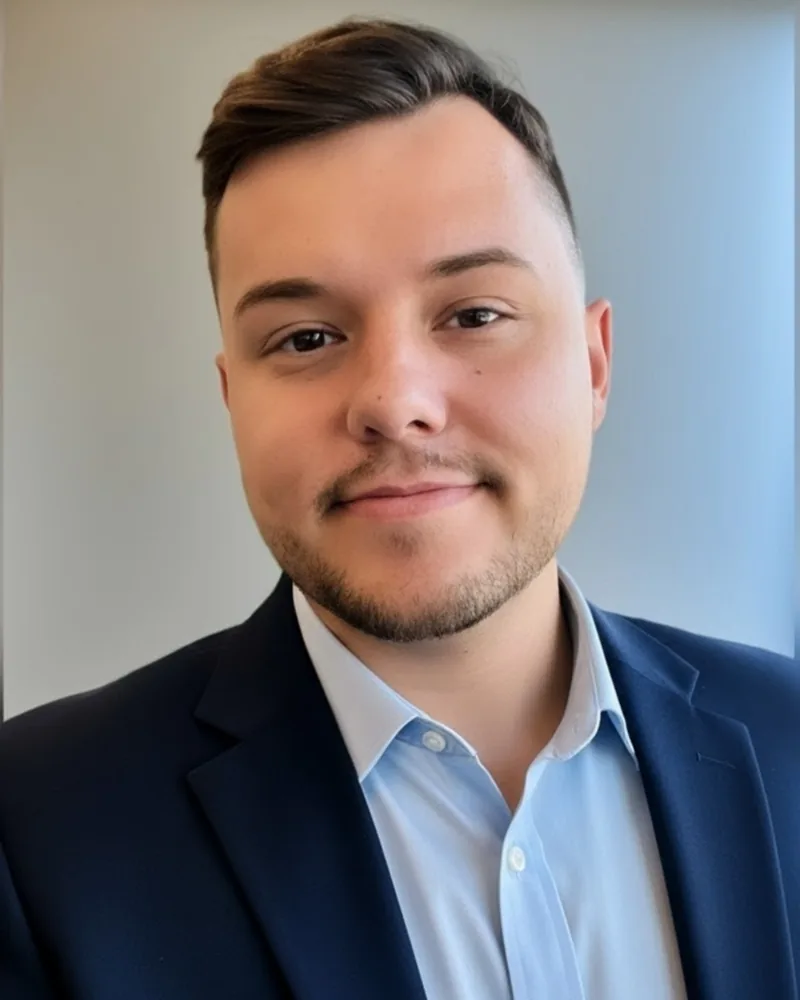 Jeremy Bish professional headshot in a navy suit